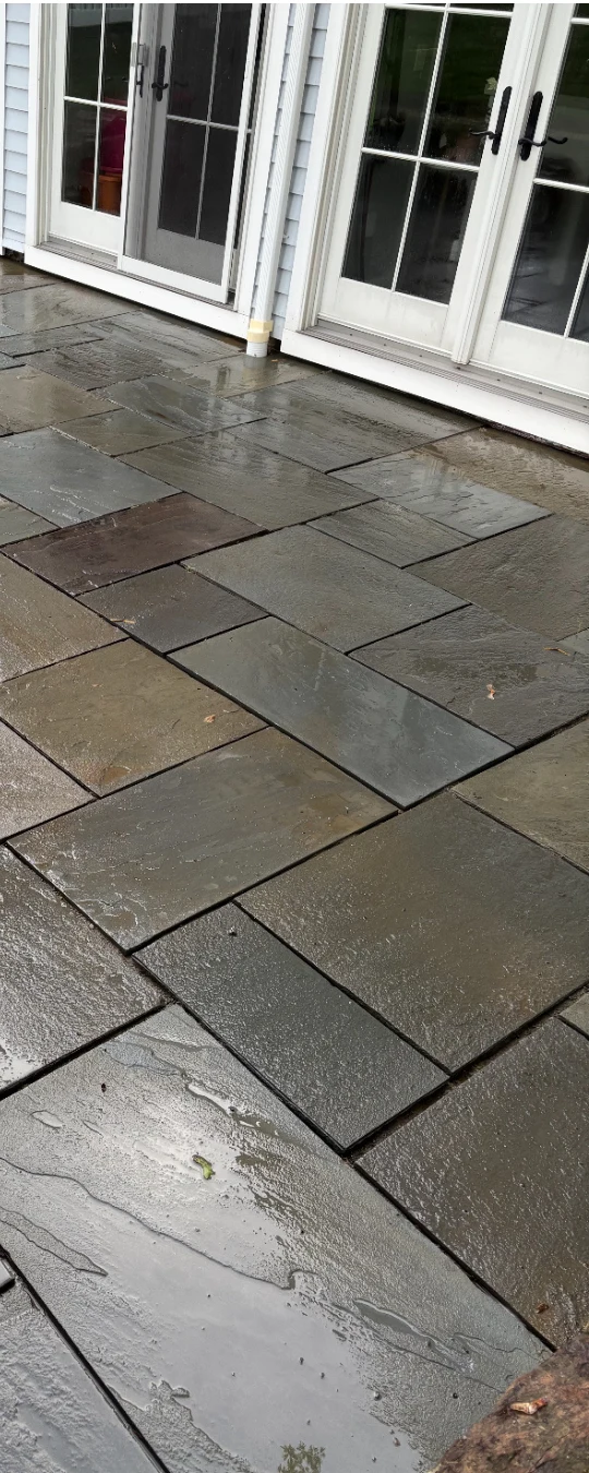 After: a bluestone patio behind a set of French doors