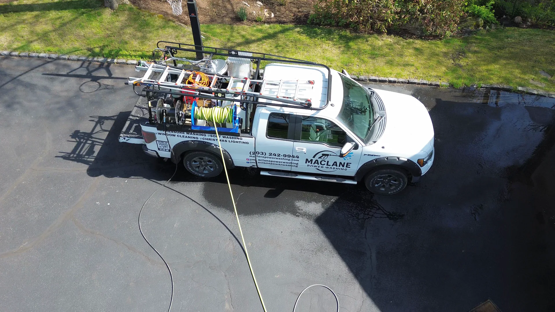 MacLane truck and equipment in a driveway, aerial